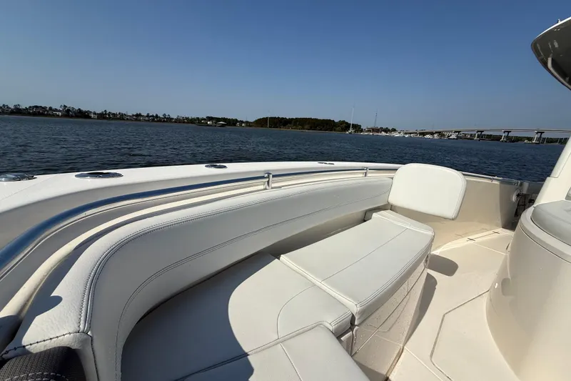 Slide: The Image of 2023 Cobia 350 Center Console boat with white seating, on calm water. - 31