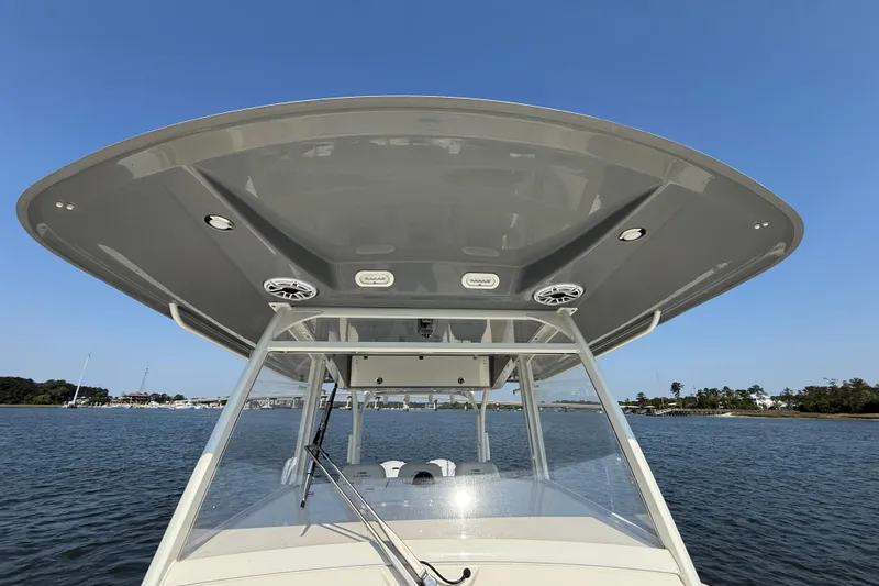 Slide: The Image of 2023 Cobia 350 Center Console boat on water, showcasing sleek design and spacious deck. - 32