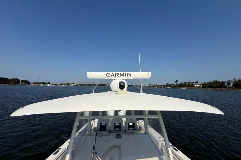 Slide: The Image of 2023 Cobia 350 Center Console boat with Garmin radar on calm water. - 34