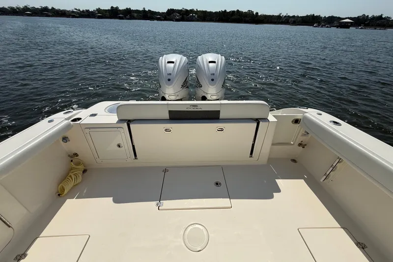 Slide: The Image of 2023 Cobia 350 Center Console boat with dual engines on calm water. - 35