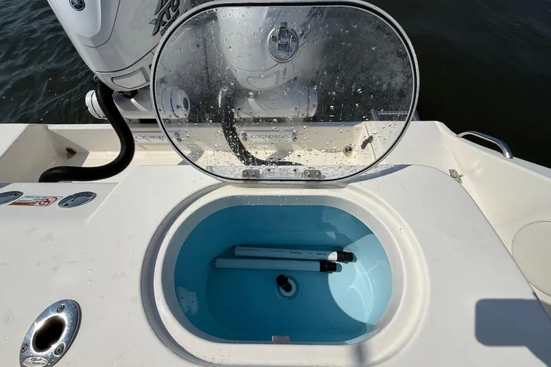 Slide: The Image of 2023 Cobia 350 Center Console boat with open livewell and Yamaha engine. - 38