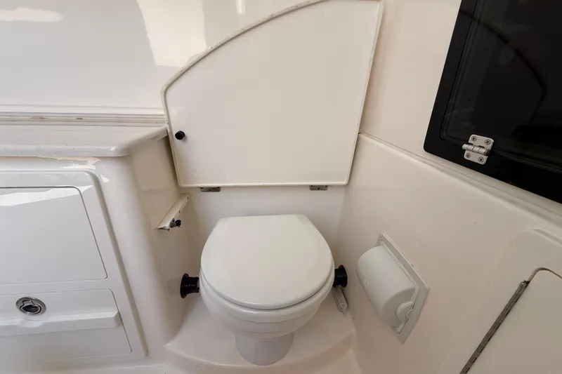 Slide: The Image of 2023 Cobia 350 Center Console boat interior with compact marine toilet. - 40