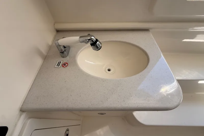 Slide: The Image of 2023 Cobia 350 Center Console boat sink with faucet on white countertop. - 41