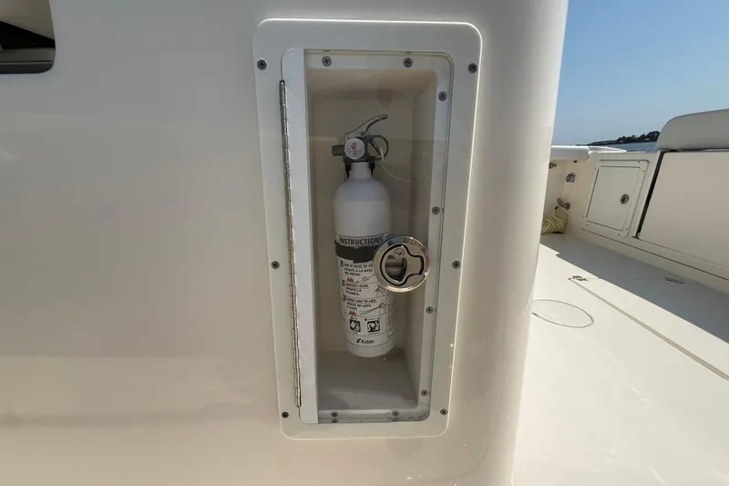 Slide: The Image of Fire extinguisher compartment on 2023 Cobia 350 Center Console boat deck. - 45