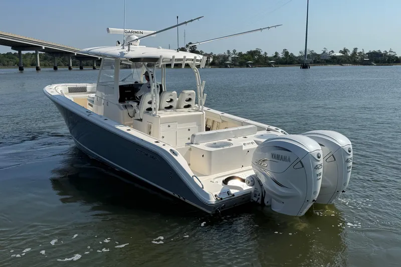 Slide: The Image of 2023 Cobia 350 Center Console boat with twin Yamaha engines on calm water. - 5