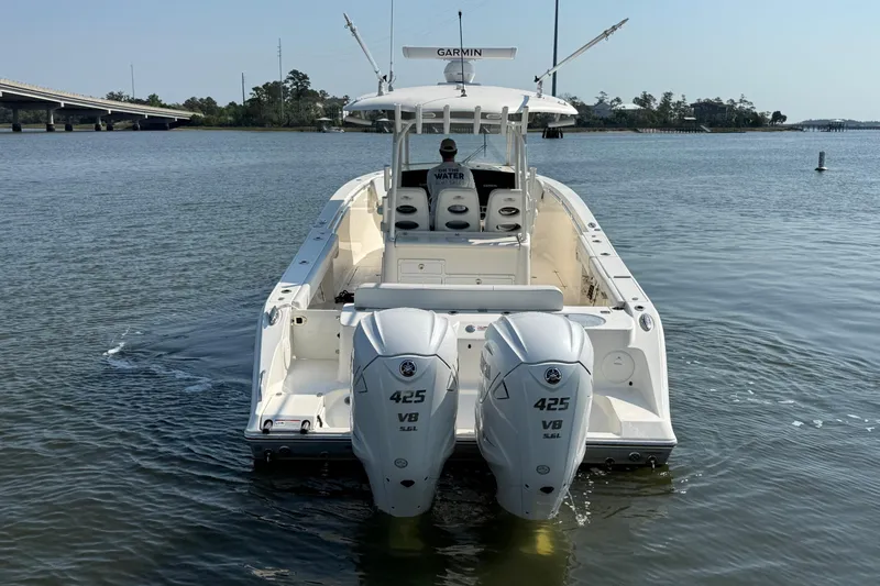 Slide: The Image of 2023 Cobia 350 Center Console boat with twin 425 V8 engines on calm water. - 6