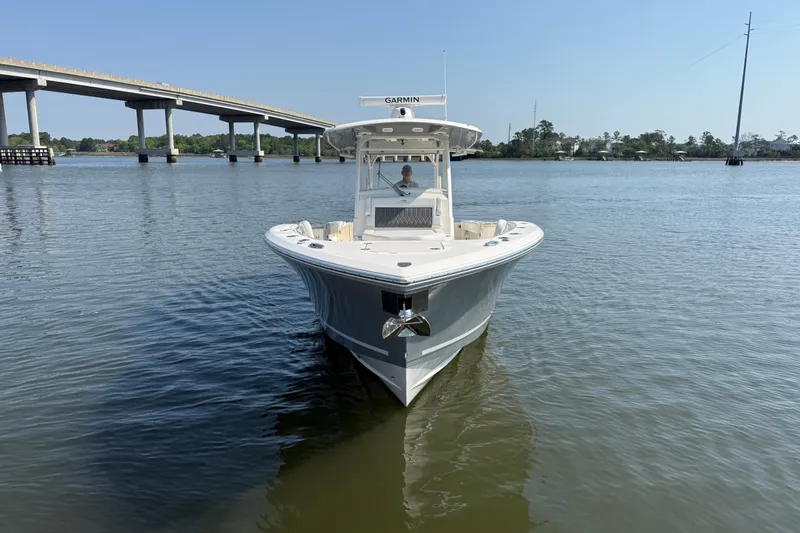 Slide: The Image of 2023 Cobia 350 Center Console boat on calm water near a bridge. - 7