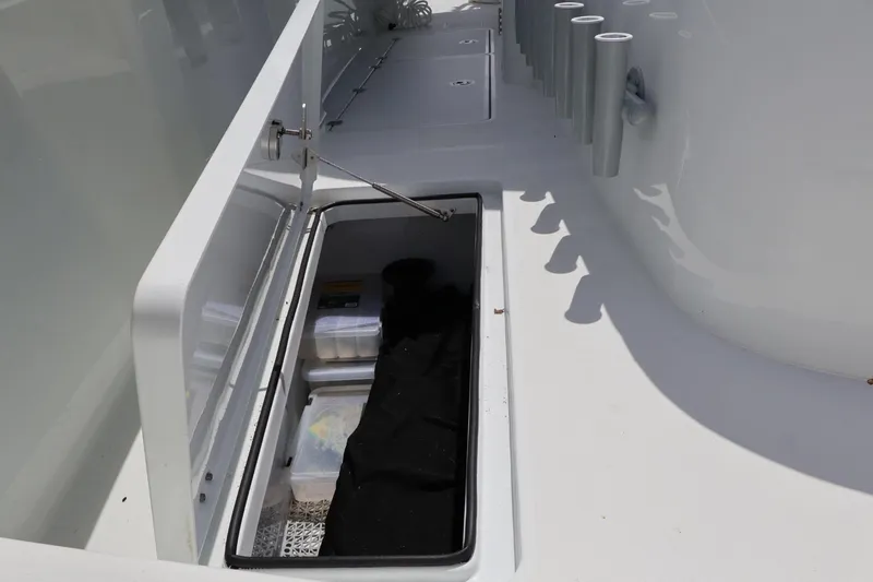 Slide: The Image of Storage compartment on a 2021 Freeman 42LR boat, featuring organized gear and accessories. - 17