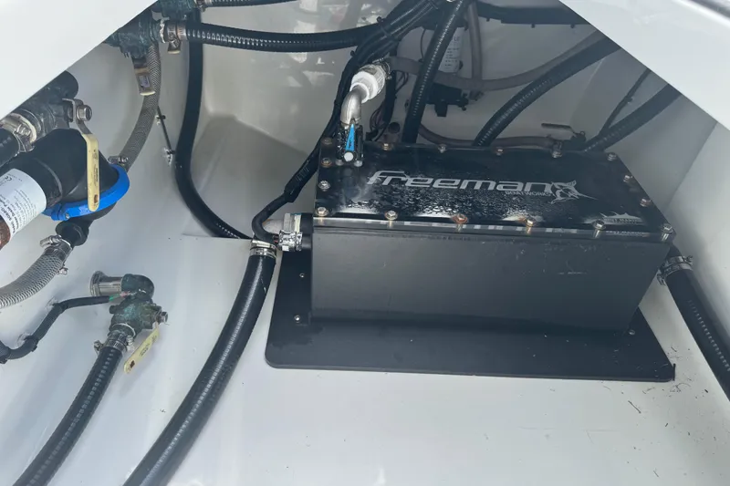 Slide: The Image of Engine compartment of a 2021 Freeman 42LR boat, showcasing wiring and components. - 19