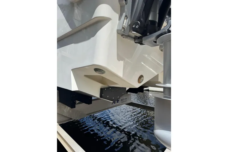 Slide: The Image of Close-up of a 2021 Freeman 42LR boat's hull and motor mount over water. - 21