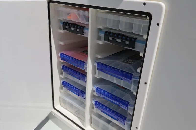 Slide: The Image of Storage compartment with organized tackle boxes on a 2021 Freeman 42LR boat. - 6