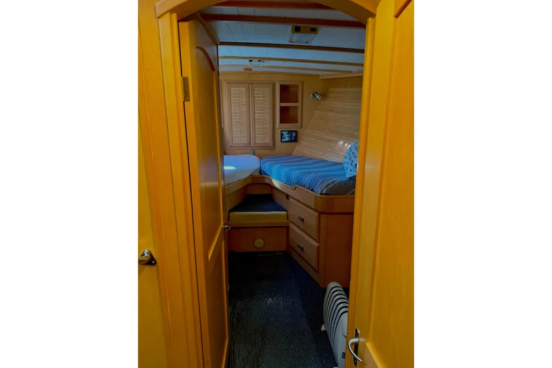 Slide: The Image of Cozy cabin interior of 1998 Waterline Pilothouse with wooden furnishings and bed. - 10