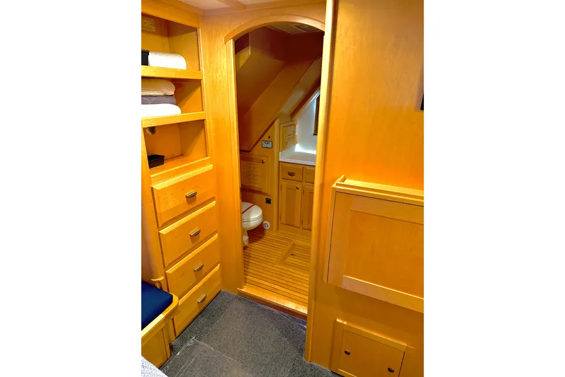 Slide: The Image of Interior of 1998 Waterline Pilothouse with wooden cabinetry and compact bathroom. - 11