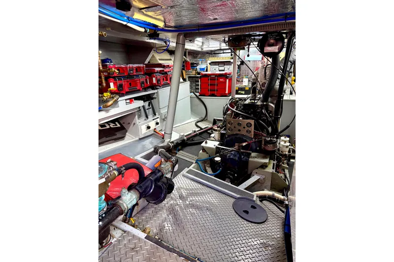 Slide: The Image of Engine room of a 1998 Waterline Pilothouse boat, showcasing machinery and equipment. - 16