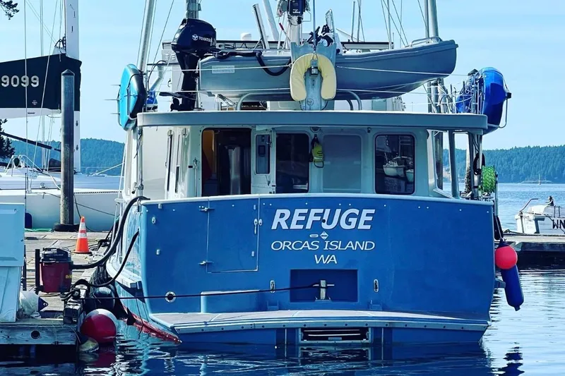 Slide: The Image of Blue Waterline Pilothouse boat "Refuge" docked at Orcas Island, WA, 1998 model. - 2