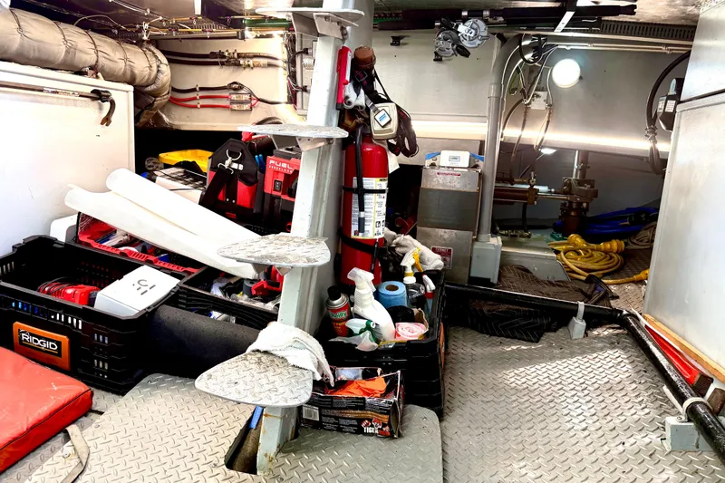 Slide: The Image of Engine room of a 1998 Waterline Pilothouse with tools and equipment. - 20