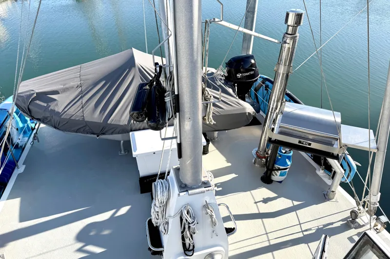 Slide: The Image of Deck of 1998 Waterline Pilothouse boat with covered equipment and Tohatsu motor. - 23