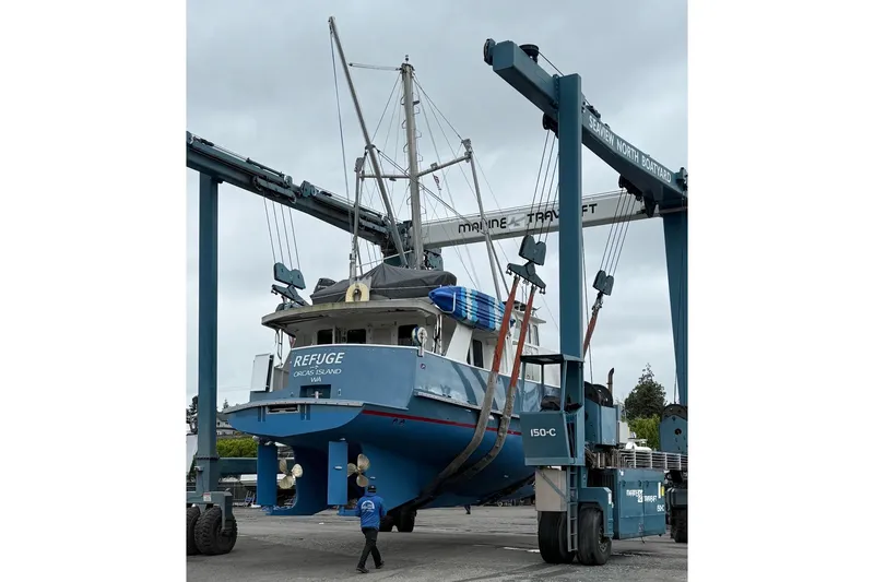 Slide: The Image of A 1998 Waterline Pilothouse boat being lifted at Seaview North Boatyard. - 3