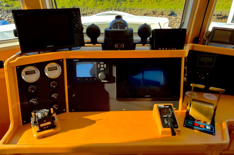 Slide: The Image of 1998 Waterline Pilothouse dashboard with navigation and control instruments. - 7