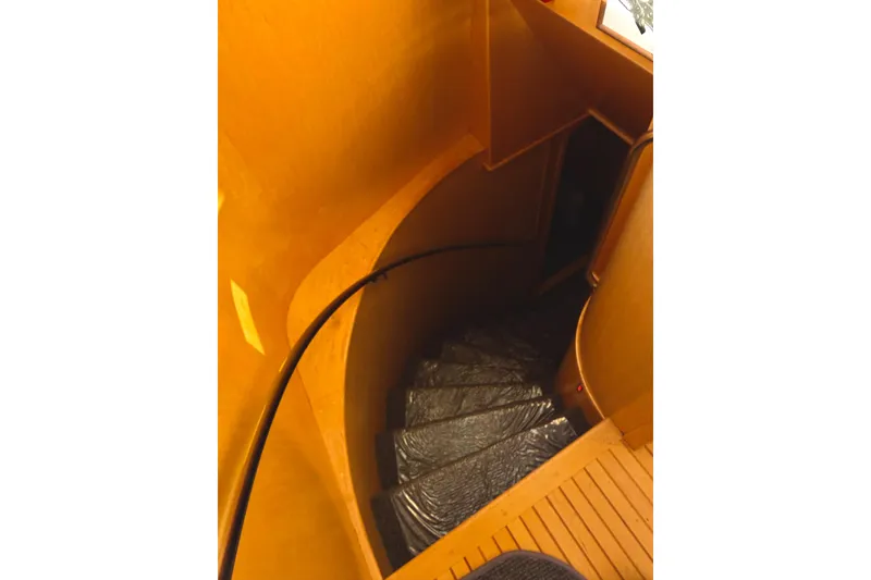 Slide: The Image of Curved wooden staircase inside 1998 Waterline Pilothouse yacht. - 9