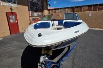 Slide: The Image of 2012 Four Winns H180LE boat on trailer, parked outdoors. - 4