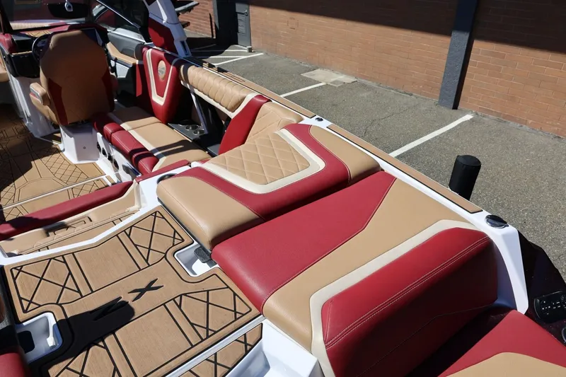 Slide: The Image of 2022 Tigé 25ZX boat interior with red and tan leather seating, showcasing luxury design. - 26
