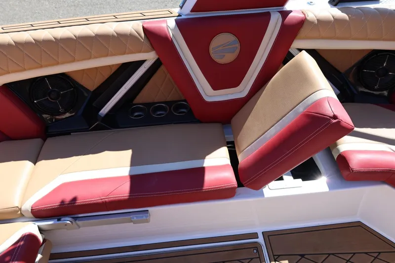 Slide: The Image of 2022 Tigé 25ZX boat interior with red and tan leather seating and built-in speakers. - 41