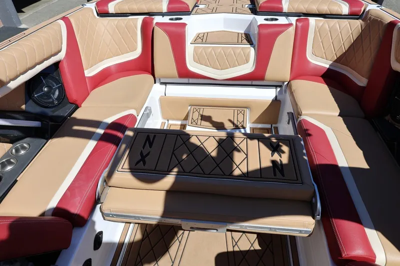 Slide: The Image of 2022 Tigé 25ZX boat interior with tan and red upholstery, featuring diamond stitching. - 43