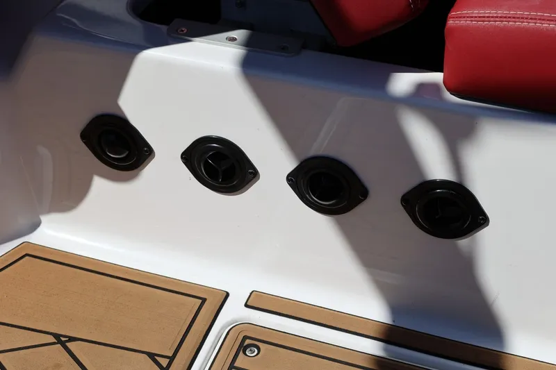 Slide: The Image of 2022 Tigé 25ZX boat interior with red seats and black speaker vents. - 45