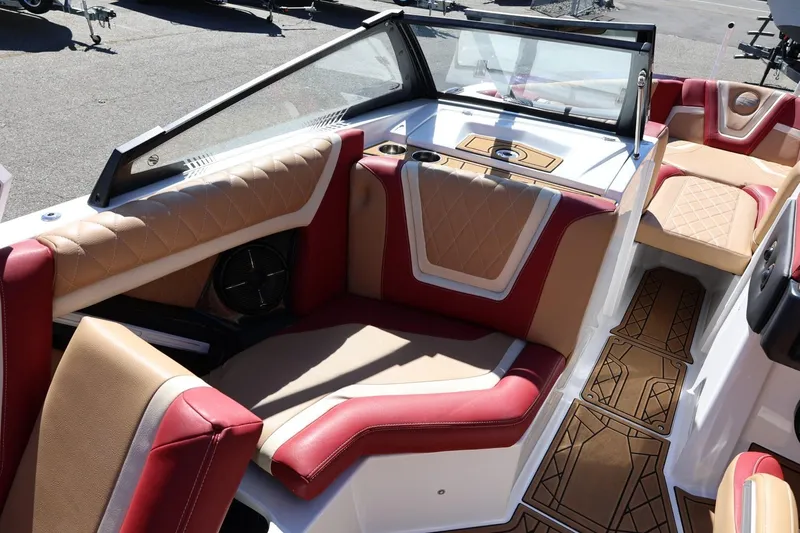 Slide: The Image of 2022 Tigé 25ZX boat interior with luxurious red and tan seating. - 46