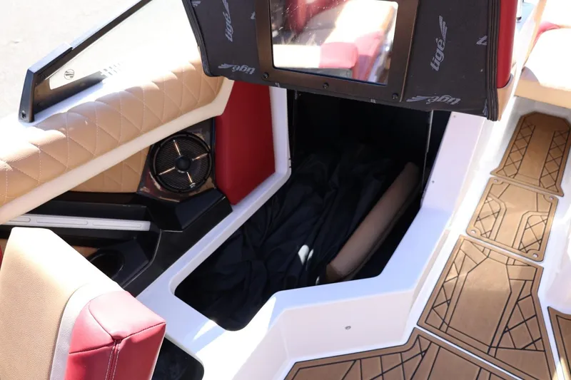 Slide: The Image of 2022 Tigé 25ZX boat interior with tan upholstery and storage compartment. - 47