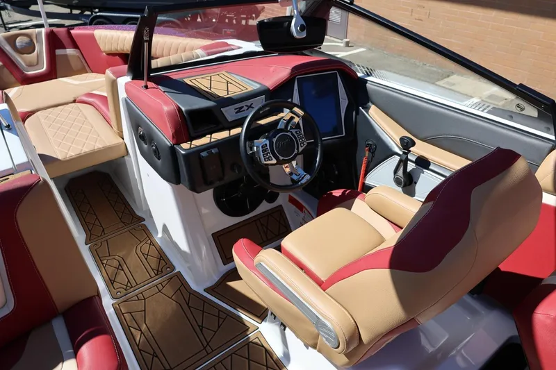 Slide: The Image of 2022 Tigé 25ZX boat interior with luxurious seating and modern dashboard design. - 48