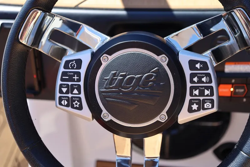 Slide: The Image of Steering wheel of 2022 Tigé 25ZX boat with control buttons. - 50