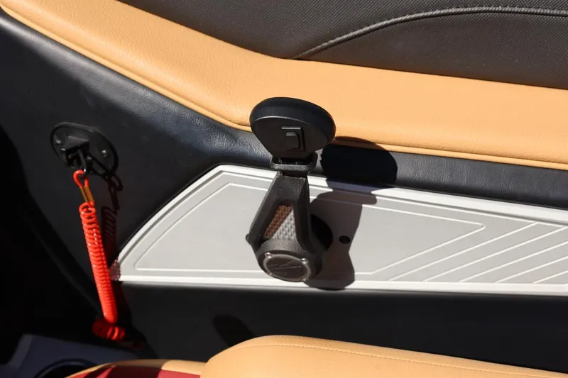Slide: The Image of Interior detail of 2022 Tigé 25ZX boat, featuring tan upholstery and safety equipment. - 53