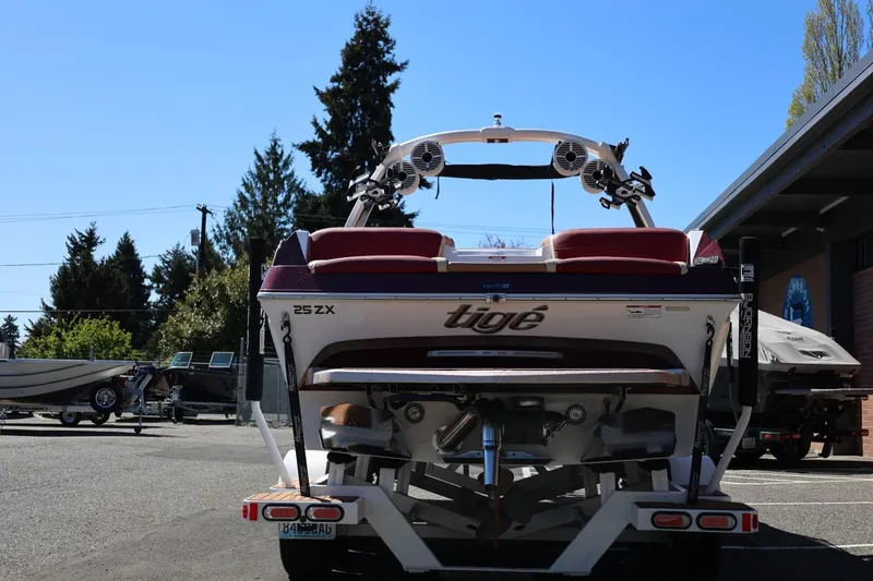 Slide: The Image of 2022 Tigé 25ZX boat on trailer, rear view, parked outdoors. - 6