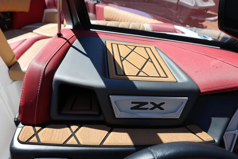 Slide: The Image of 2022 Tigé 25ZX boat interior with red and tan upholstery, featuring ZX branding. - 60