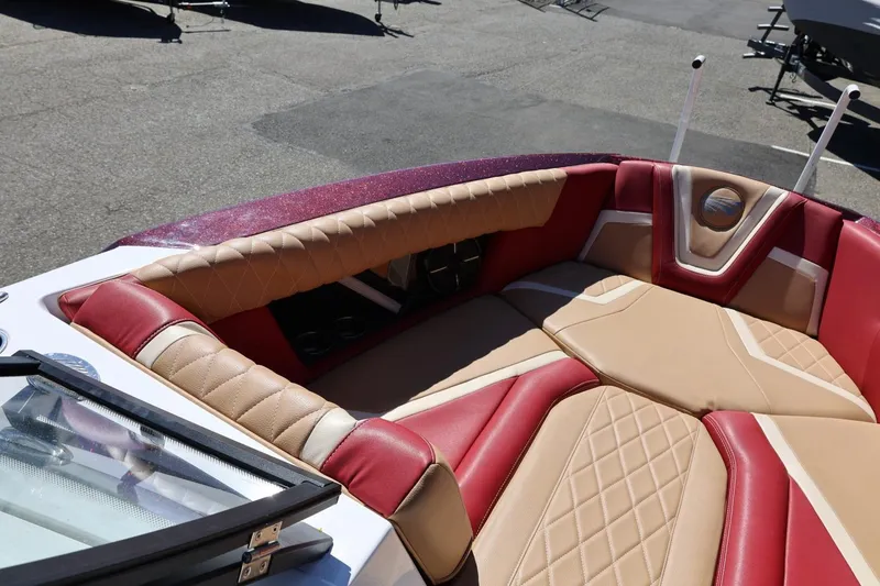 Slide: The Image of 2022 Tigé 25ZX boat interior with red and beige cushioned seating. - 62