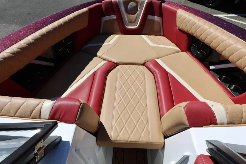 Slide: The Image of 2022 Tigé 25ZX boat interior with red and beige diamond-stitched upholstery. - 64