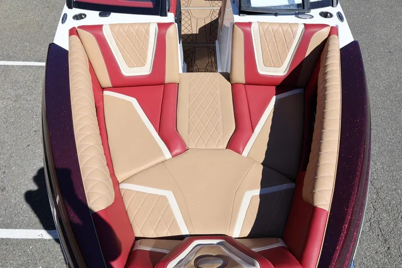 Slide: The Image of 2022 Tigé 25ZX boat interior with red and beige cushioned seating. - 65