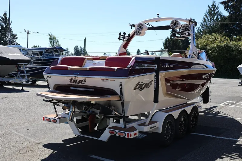 Slide: The Image of 2022 Tigé 25ZX boat on trailer in parking lot, rear view. - 7