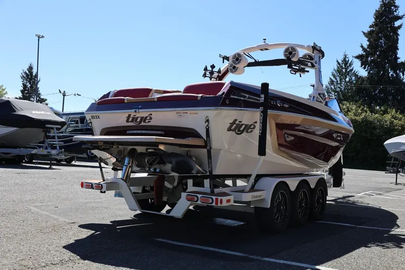 Slide: The Image of 2022 Tigé 25ZX boat on trailer in parking lot, rear view. - 8
