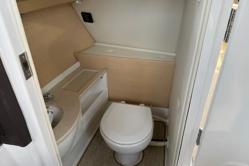 Slide: The Image of 2015 Cobalt 26SD boat bathroom with toilet and sink. - 10