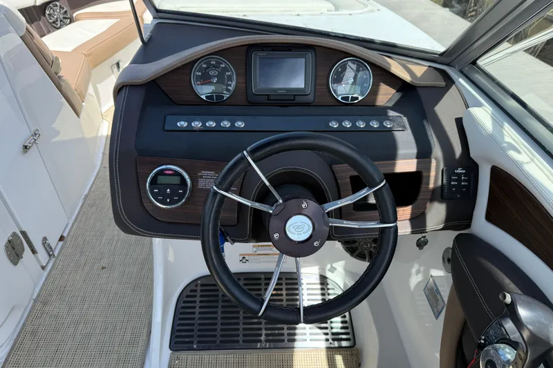 Slide: The Image of 2015 Cobalt 26SD boat dashboard with steering wheel and control panel. - 11