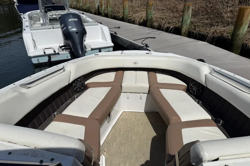 Slide: The Image of 2015 Cobalt 26SD boat with spacious seating, docked by the water. - 14