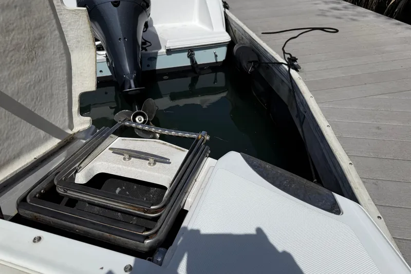 Slide: The Image of 2015 Cobalt 26SD boat stern with outboard motor and swim platform ladder. - 15