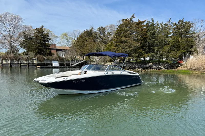 Slide: The Image of 2015 Cobalt 26SD boat on calm water with trees in the background. - 3