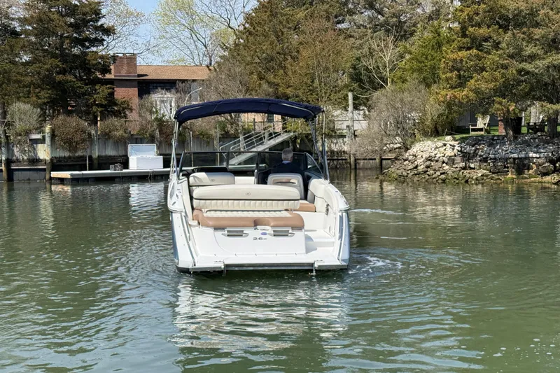Slide: The Image of 2015 Cobalt 26SD boat on calm water near a wooded shoreline. - 7