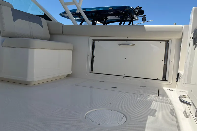 Slide: The Image of Interior view of 2026 Sailfish 276 DC boat, featuring seating and storage compartment. - 13