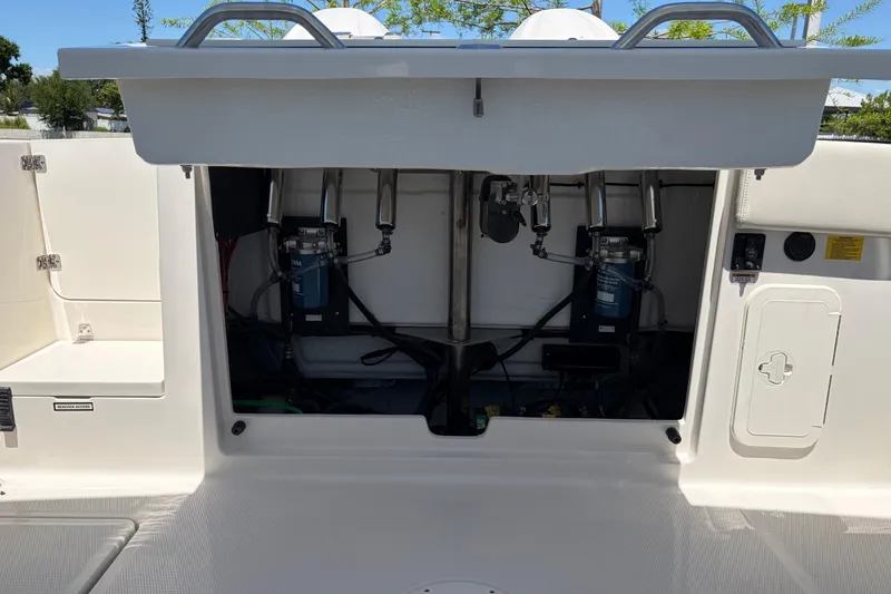 Slide: The Image of Open engine compartment of 2026 Sailfish 276 DC boat, showcasing mechanical components. - 14