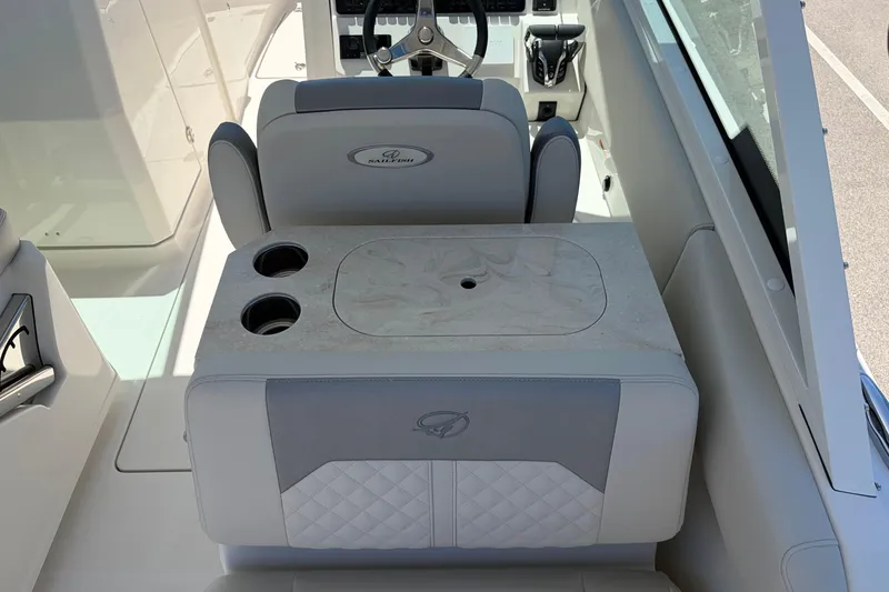 Slide: The Image of 2026 Sailfish 276 DC boat interior with dual cup holders and steering wheel. - 17